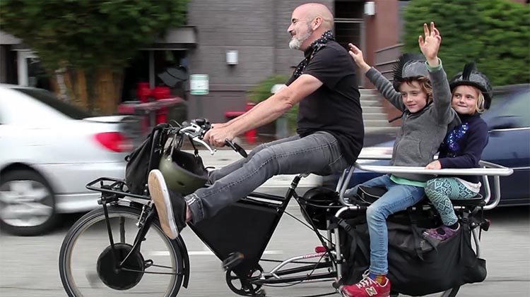 Try telling this dad that he is not getting any exercise because he is "cheating" by getting some assistance from his electric bike!